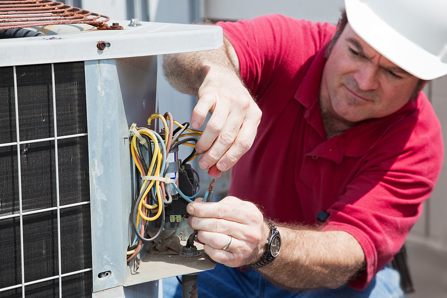 electrician repairing the air conditioner